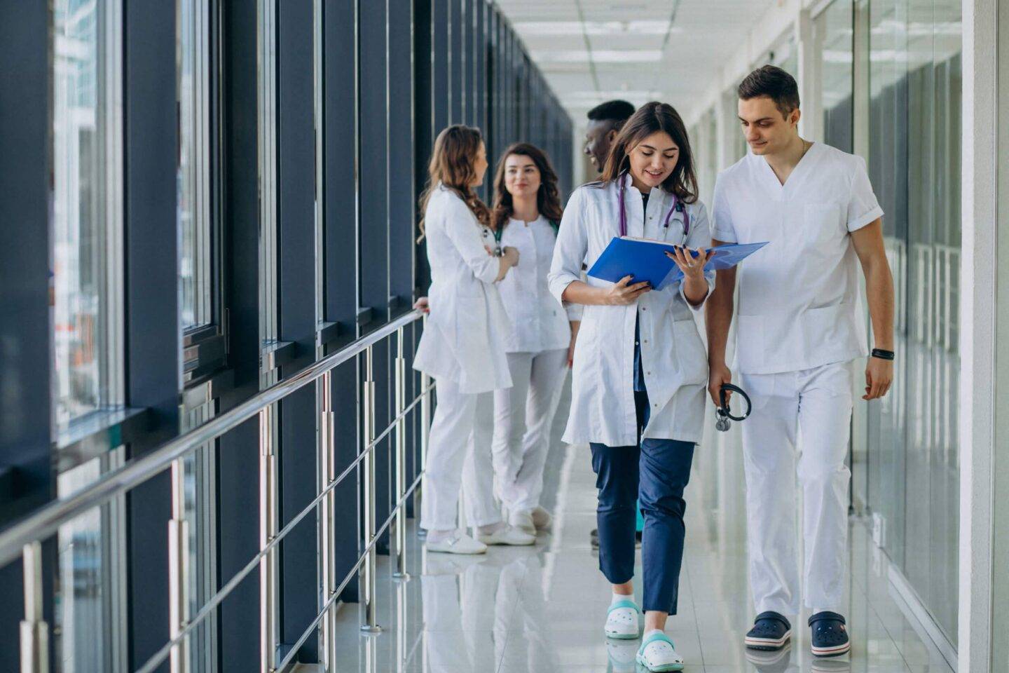 people walking in the corridor of a hospital