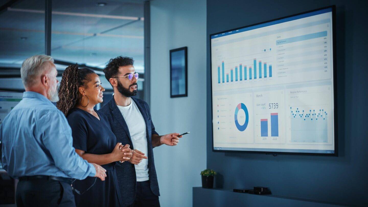 people looking at graphs on a screen